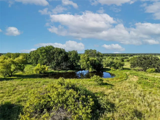 a view of a lake with houses in the back