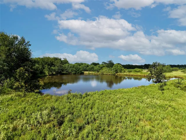 a view of a lake with houses in the background