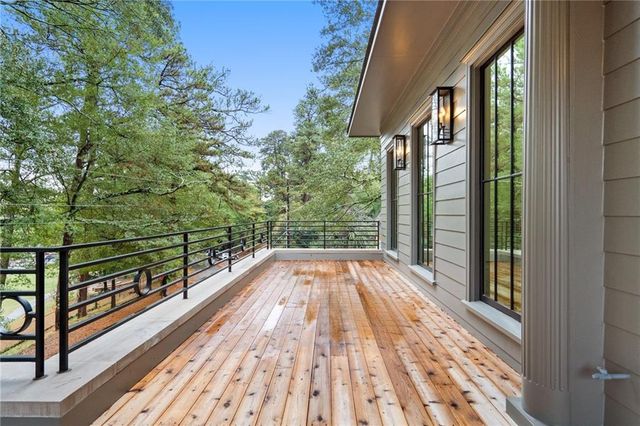 a view of balcony with wooden floor and fence