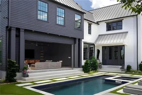 a view of a house with swimming pool and porch with furniture