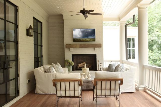a living room with furniture fireplace and flat screen tv