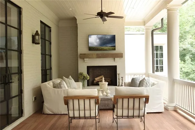 a living room with furniture fireplace and flat screen tv