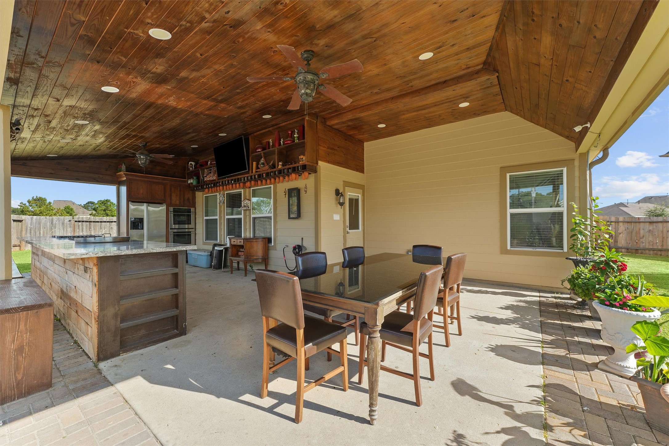 a dining room with furniture and a floor to ceiling window