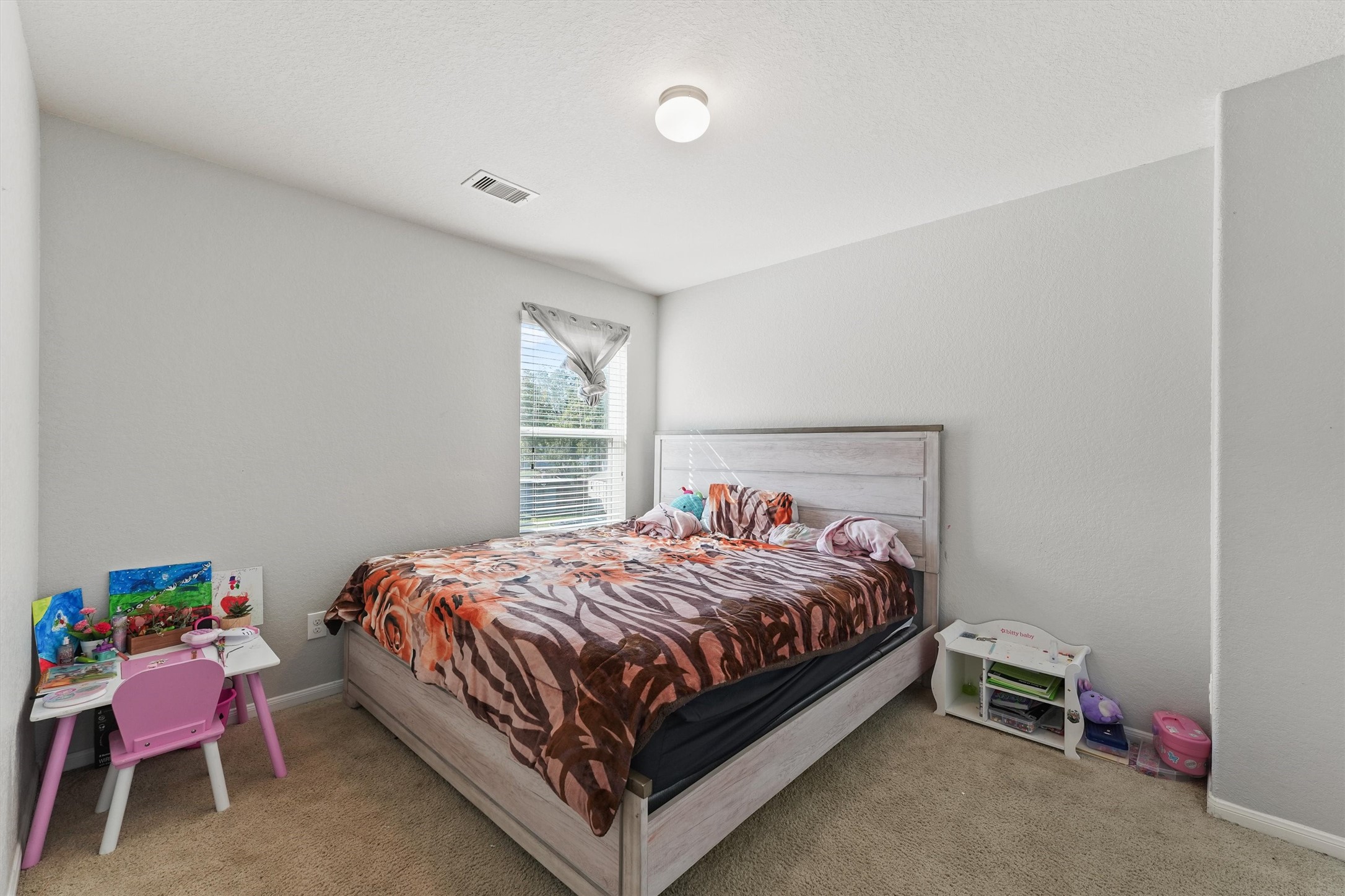 15307 Meandering Post Trail Houston, TX 77044 - Photo 16 of 25 a bed sitting in a bedroom next to a window