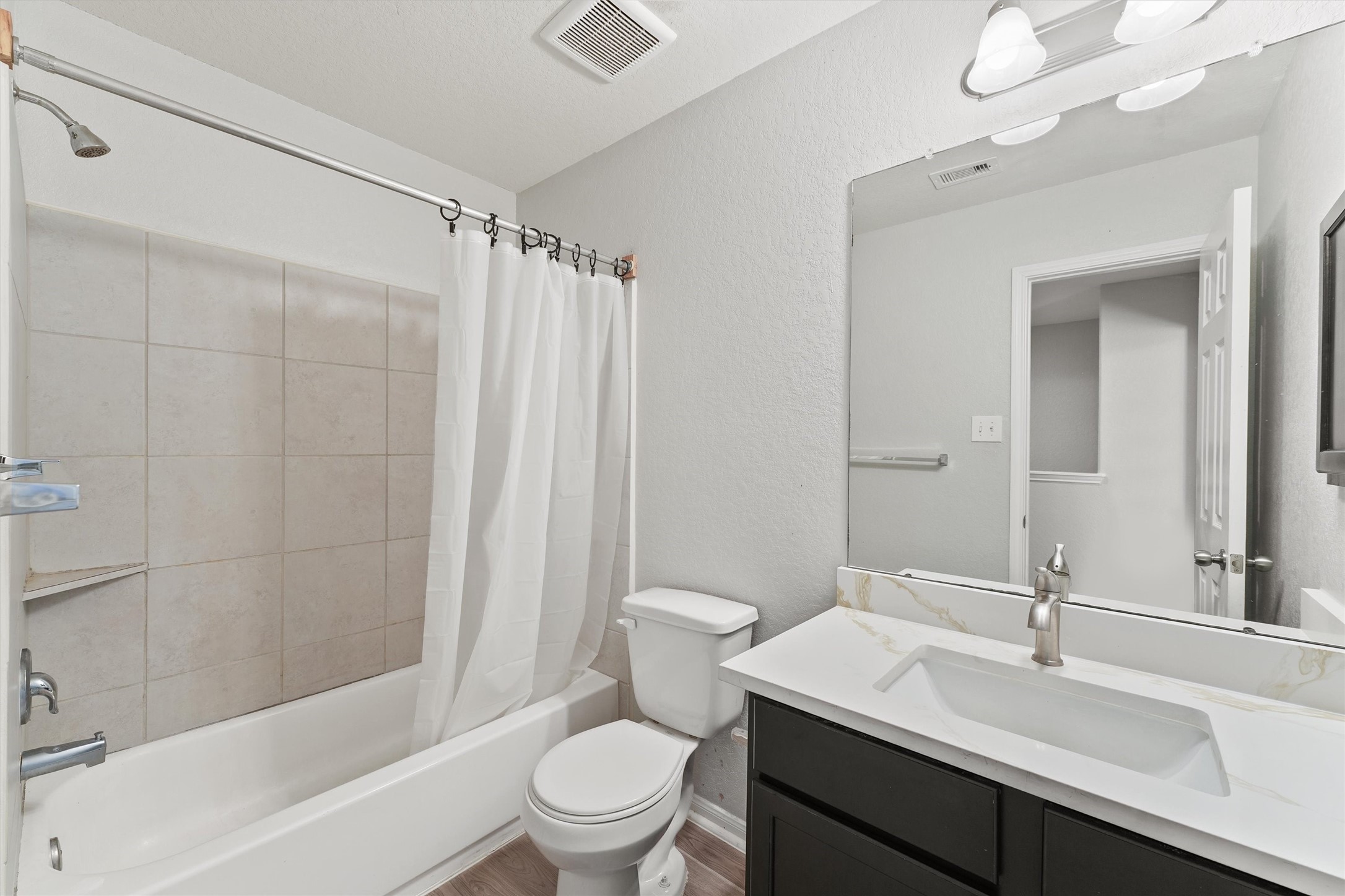 15307 Meandering Post Trail Houston, TX 77044 - Photo 17 of 25 a bathroom with a sink a toilet tub and shower