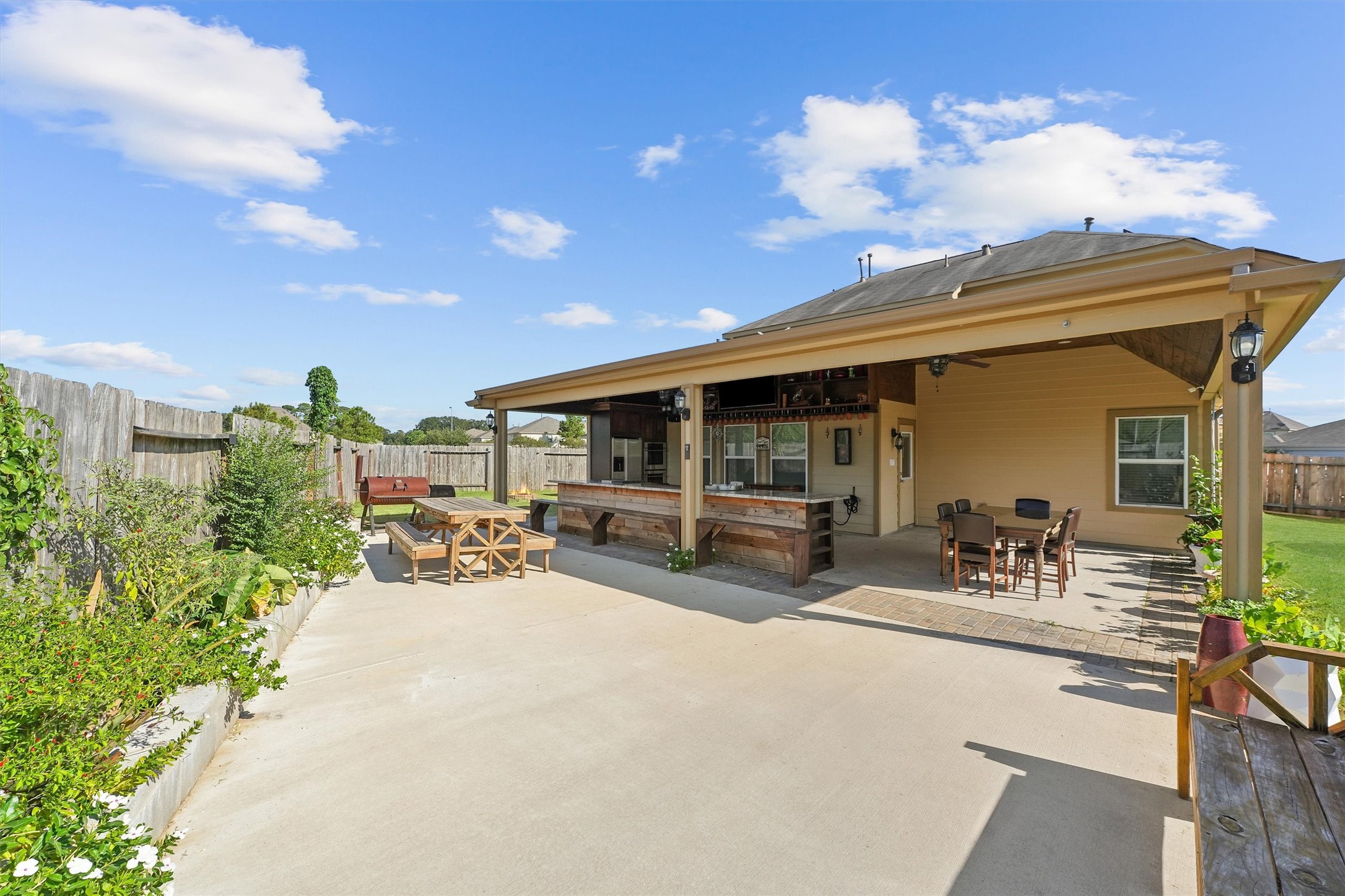 15307 Meandering Post Trail Houston, TX 77044 - Photo 2 of 25 a view of a patio with table and chairs and potted plants
