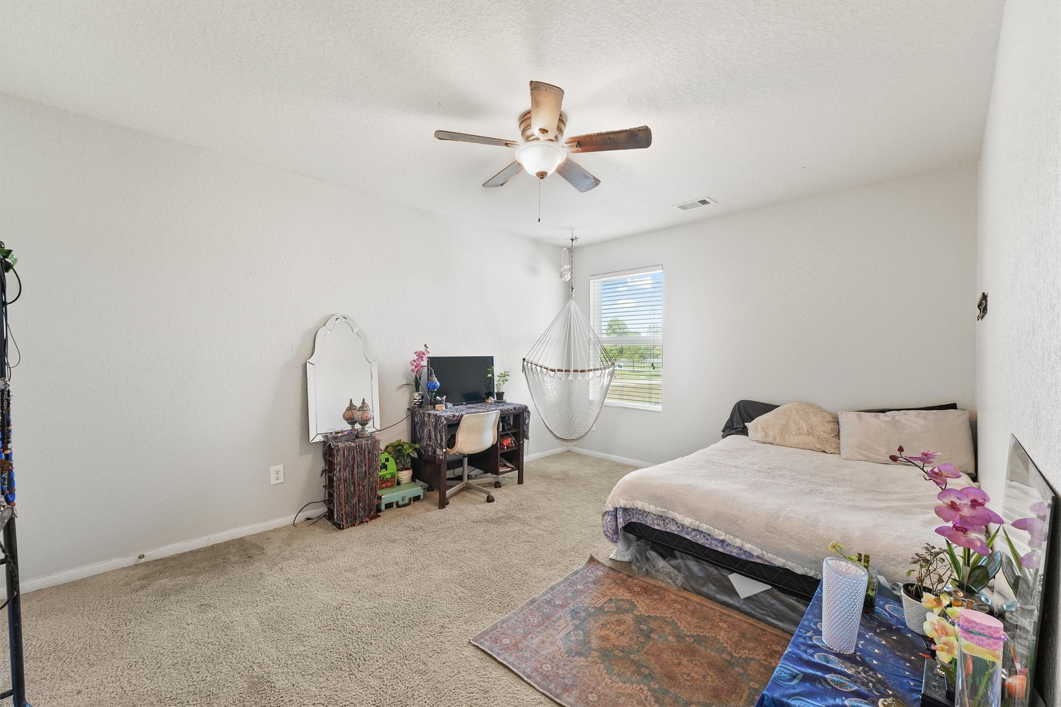 15307 Meandering Post Trail Houston, TX 77044 - Photo 21 of 25 a bedroom with a bed a chandelier and a window