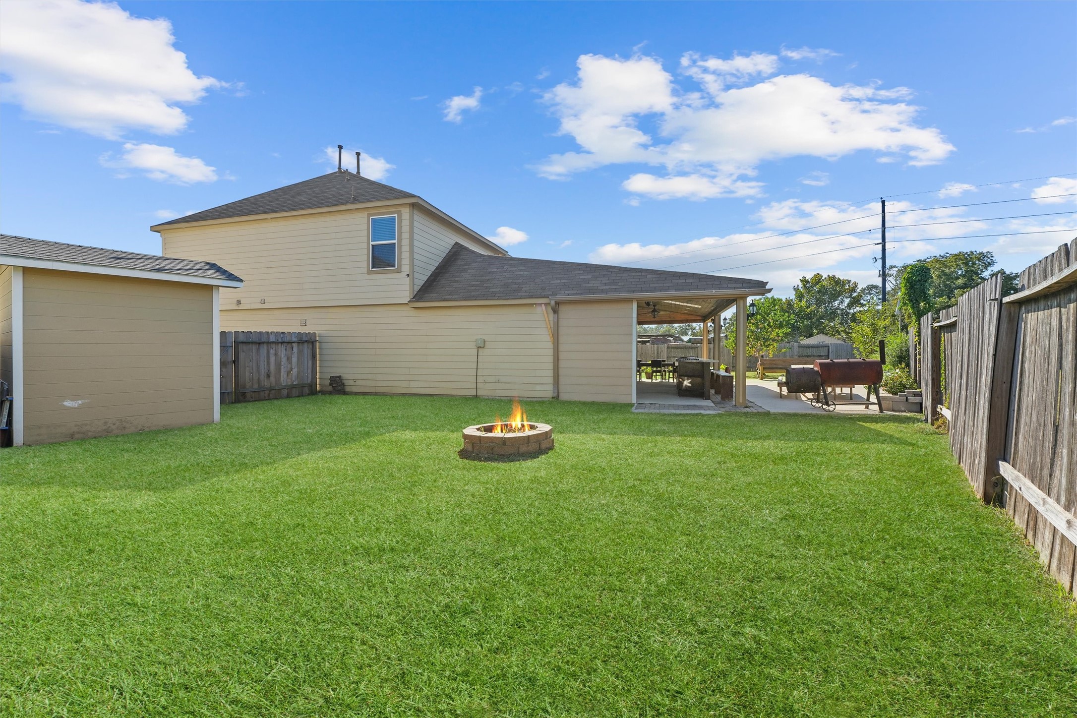 15307 Meandering Post Trail Houston, TX 77044 - Photo 25 of 25 a view of a backyard with couches plants and large trees