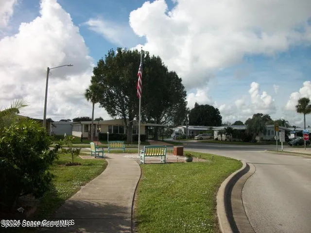 a view of building with a swimming pool
