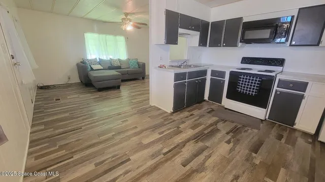 a view of kitchen with furniture and wooden floor