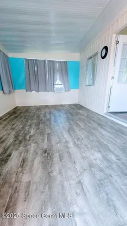a view of wooden floor and cabinet in an empty room