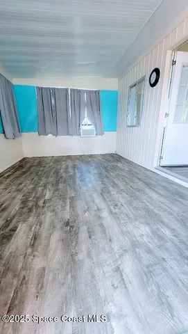 a view of wooden floor and cabinet in an empty room