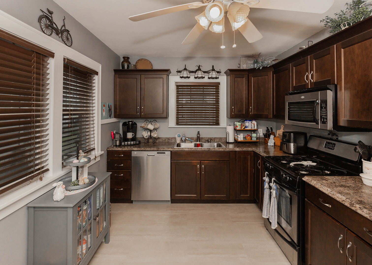 1125 17th Avenue Moline, IL 61265 - Photo 17 of 33 a kitchen with a stove a sink a microwave and cabinets