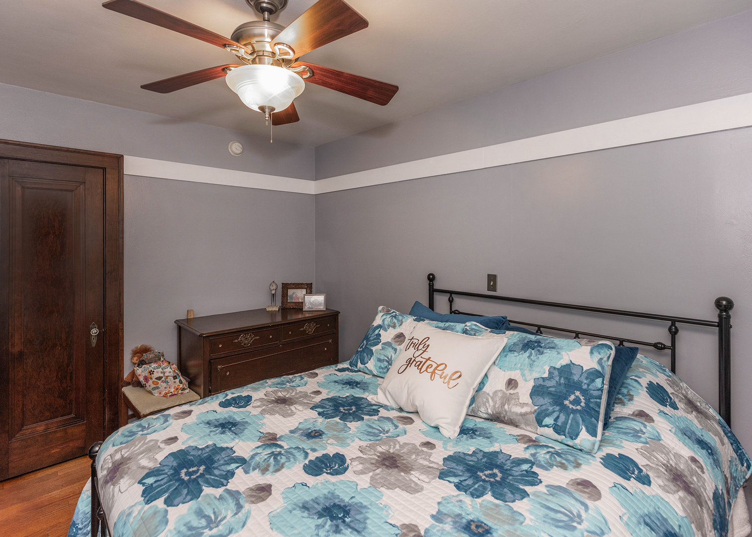 1125 17th Avenue Moline, IL 61265 - Photo 21 of 33 a bed sitting in a bedroom and a chandelier
