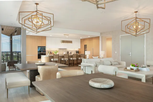 a living room with furniture and a dining table