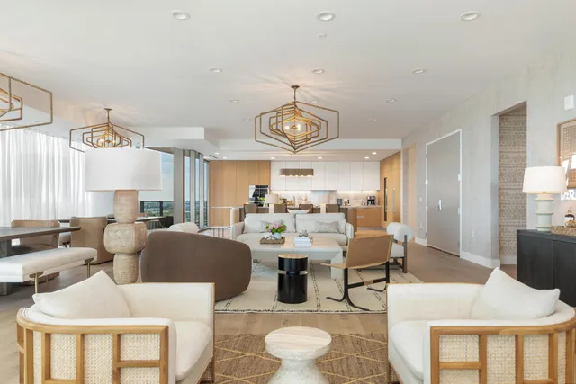 a living room with furniture and a chandelier