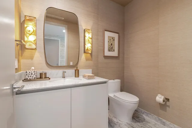 a living room with furniture a chandelier and a large window