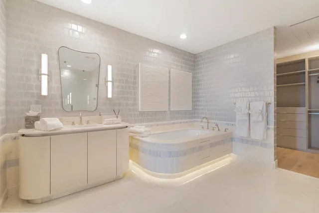 a bedroom with a large bed and a couch