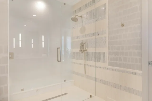 a bathroom with a tub sink and mirror