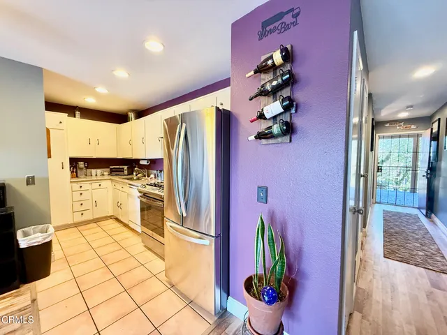 a kitchen with stainless steel appliances granite countertop a refrigerator and a stove