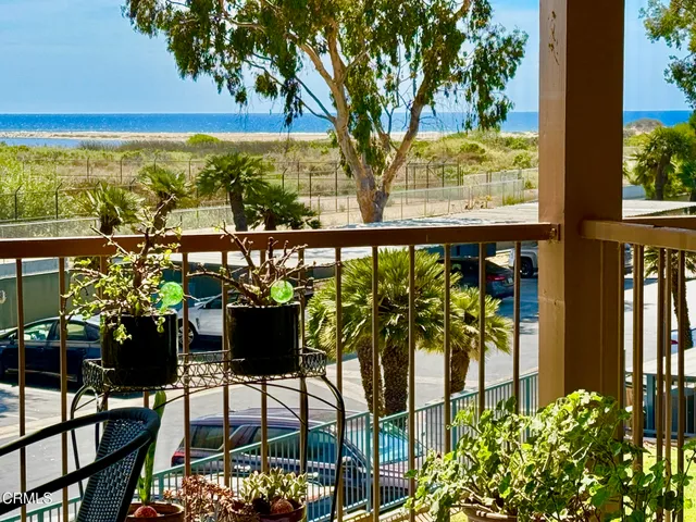 a view of a chairs and table in the balcony