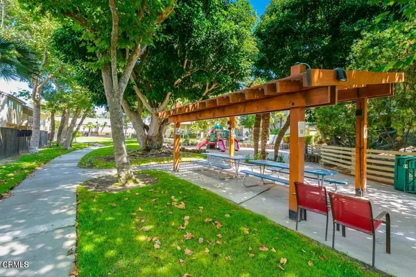 a view of a patio with a table chairs and a backyard