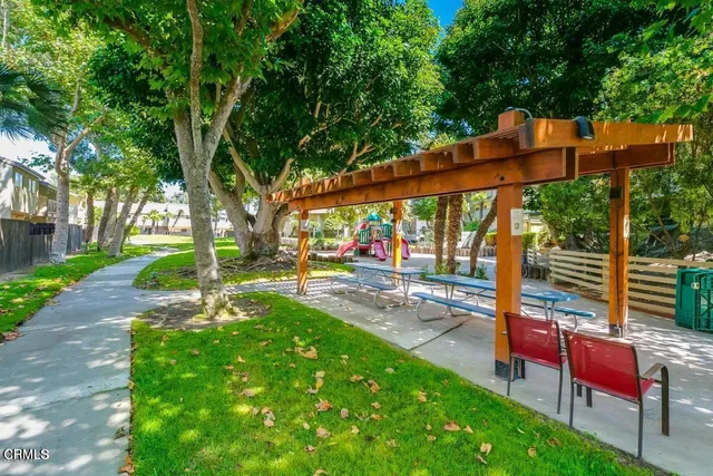 a view of a patio with a table chairs and a backyard