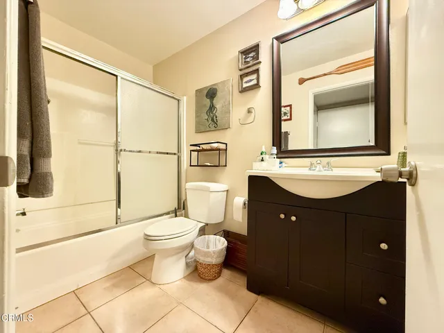 a bathroom with a sink vanity mirror and toilet