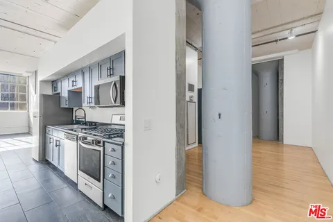 a kitchen with stainless steel appliances granite countertop a stove and a refrigerator