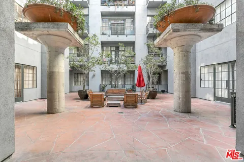 a view of a building with sitting area and garden