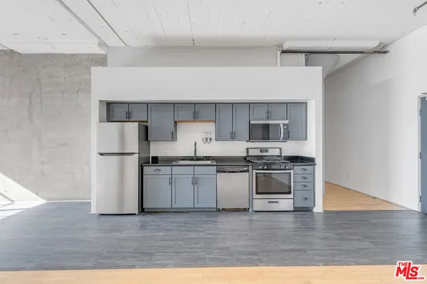 a kitchen with stainless steel appliances granite countertop a stove and a refrigerator