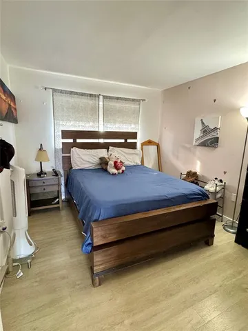 a bedroom with furniture and a window