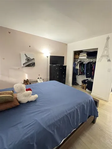 a bedroom with a bed and dresser