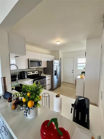 a kitchen with stainless steel appliances a sink and cabinets