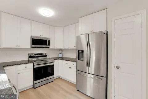 a kitchen with stainless steel appliances a refrigerator stove and microwave