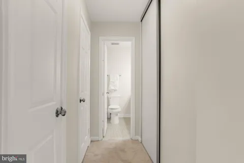 a bathroom with a granite countertop sink a toilet and a mirror
