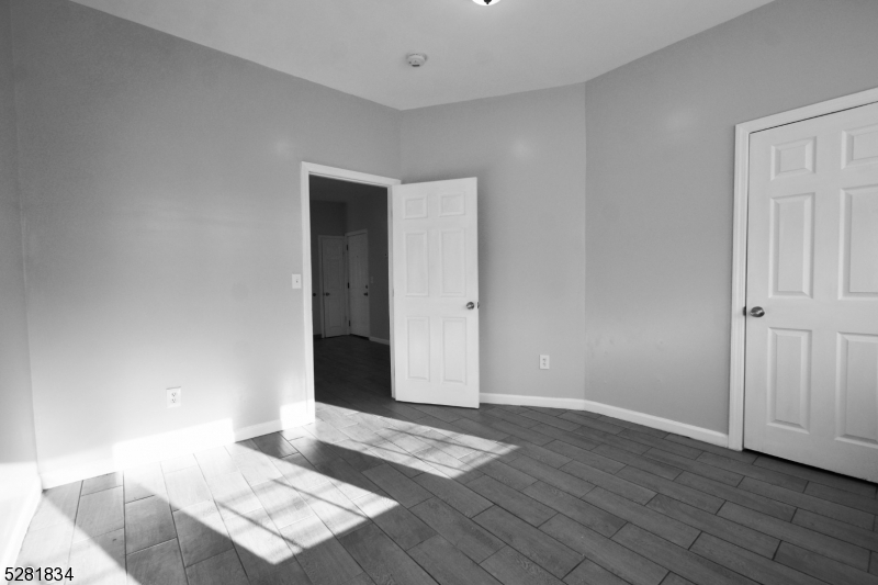 an empty room with wooden floor