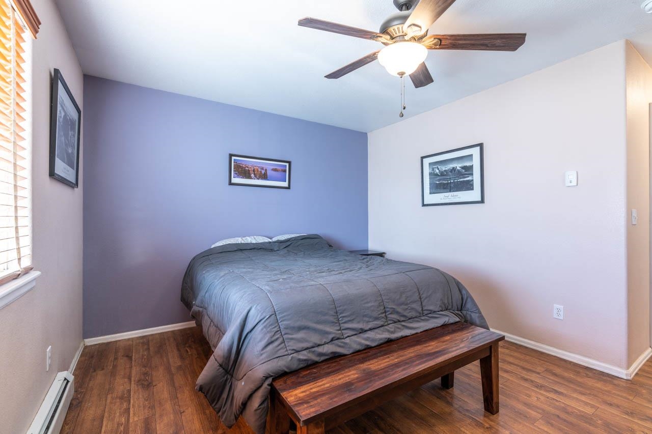 1458 Powell Street Fruita, CO 81521 - Photo 12 of 27 a bedroom with a bed and a chandelier