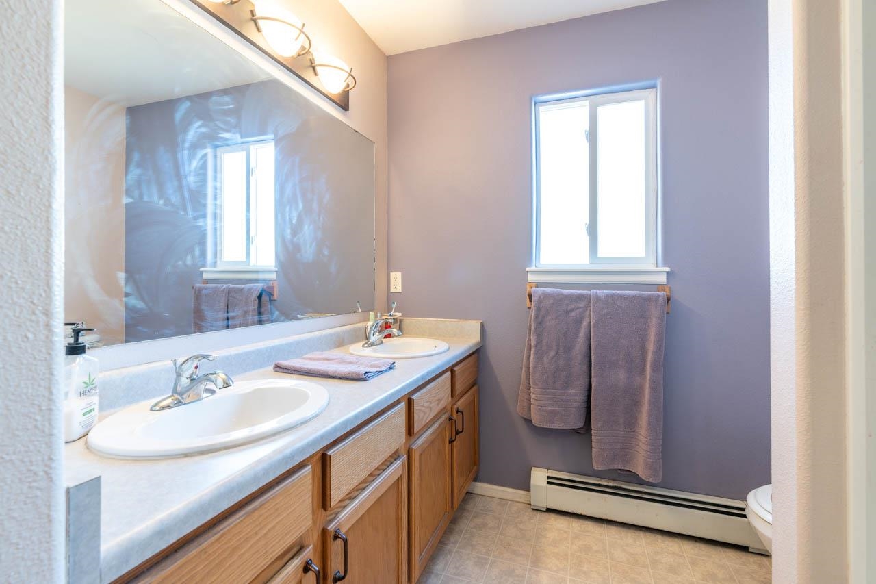 1458 Powell Street Fruita, CO 81521 - Photo 13 of 27 a bathroom with a sink double vanity and a window