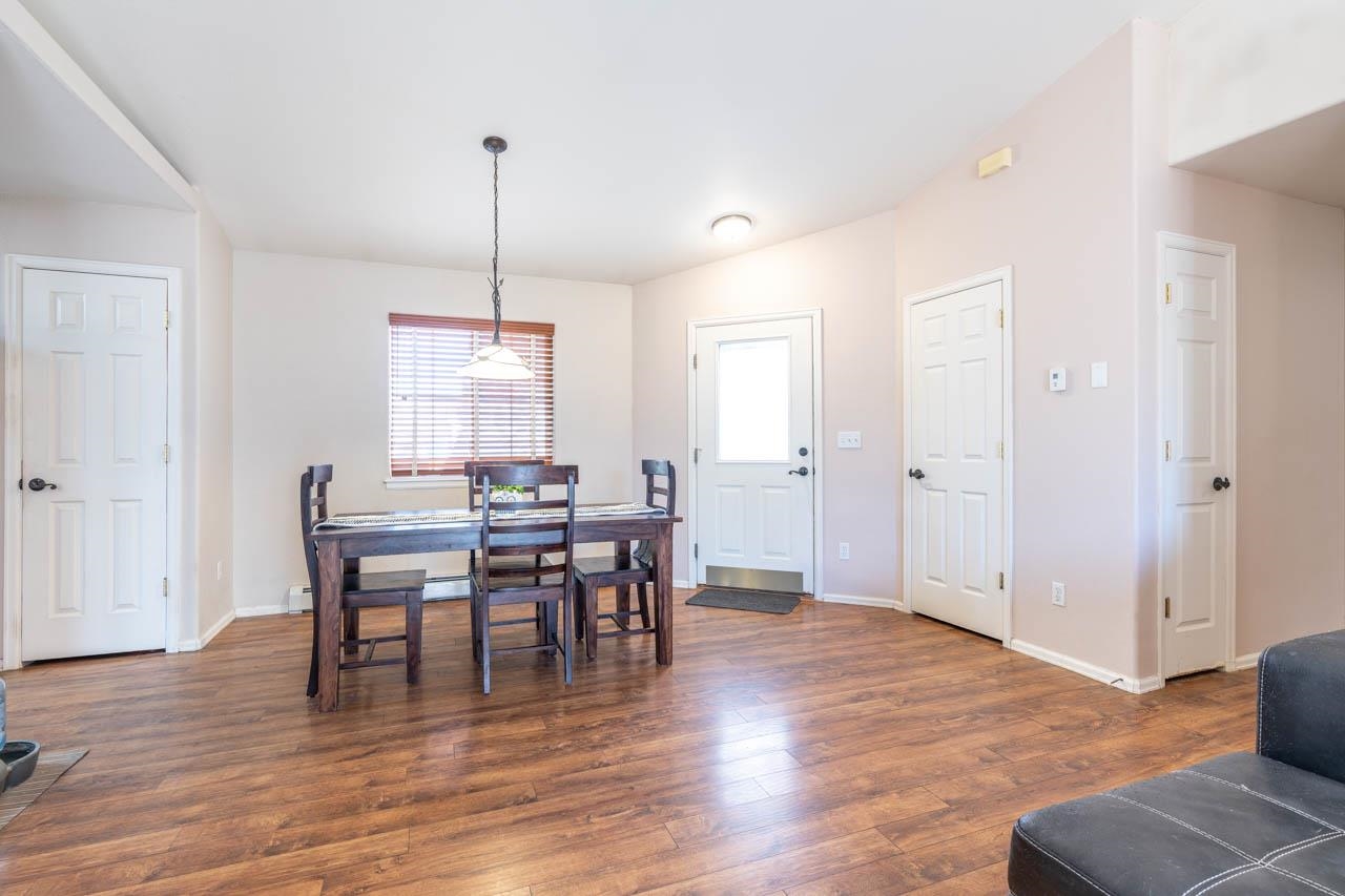 1458 Powell Street Fruita, CO 81521 - Photo 15 of 27 a view of a dining room with furniture window and wooden floor
