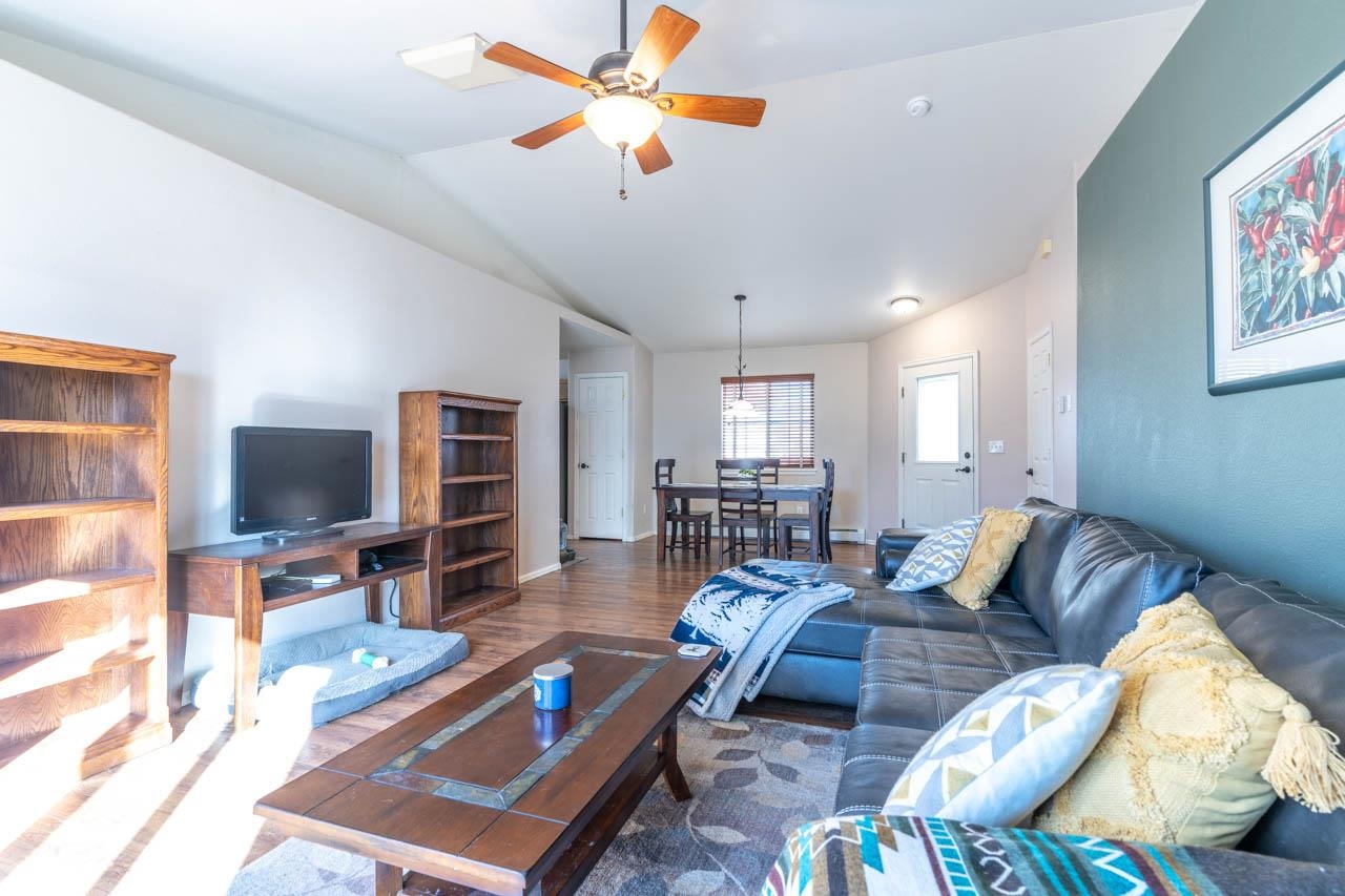 1458 Powell Street Fruita, CO 81521 - Photo 16 of 27 a living room with furniture a flat screen tv and a window