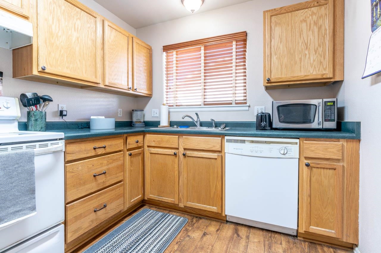 1458 Powell Street Fruita, CO 81521 - Photo 2 of 27 a kitchen with granite countertop cabinets stainless steel appliances a sink and window