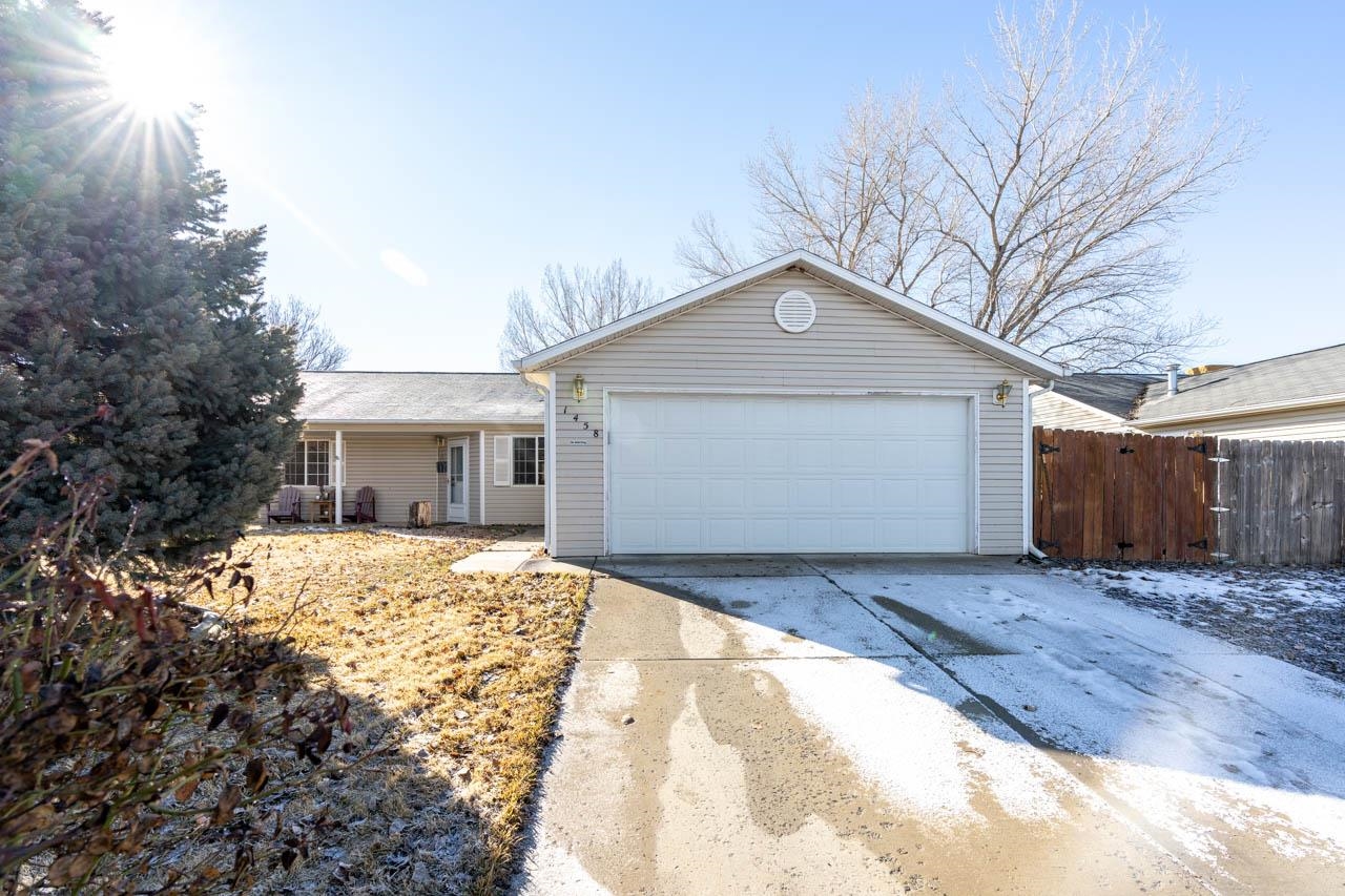 1458 Powell Street Fruita, CO 81521 - Photo 25 of 27 a front view of a house with a yard and garage