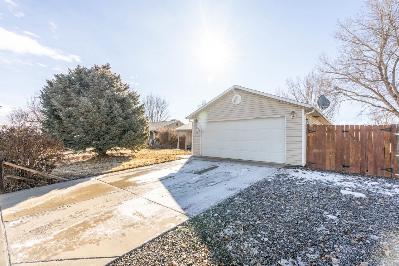 1458 Powell Street Fruita, CO 81521 - Photo 26 of 27 a view of a house with a snow in the background