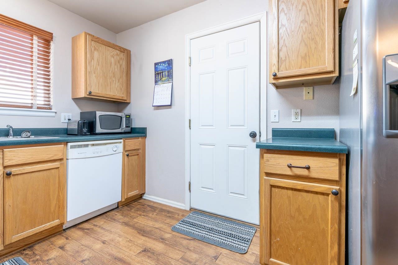 1458 Powell Street Fruita, CO 81521 - Photo 4 of 27 a kitchen with granite countertop cabinets stainless steel appliances a sink and a window