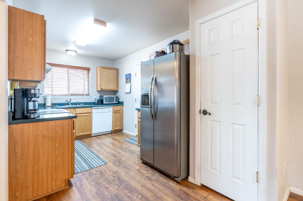 1458 Powell Street Fruita, CO 81521 - Photo 5 of 27 a kitchen with stainless steel appliances granite countertop a refrigerator a sink and a stove
