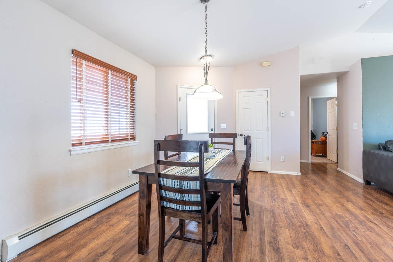 1458 Powell Street Fruita, CO 81521 - Photo 7 of 27 a view of a dining room with furniture window and wooden floor