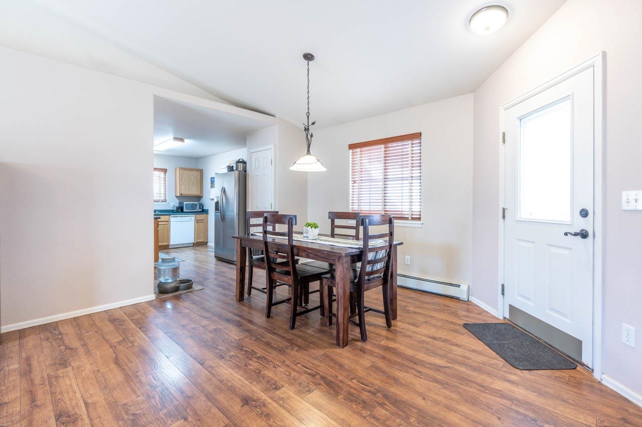 1458 Powell Street Fruita, CO 81521 - Photo 8 of 27 a view of a a dining room with furniture window and wooden floor
