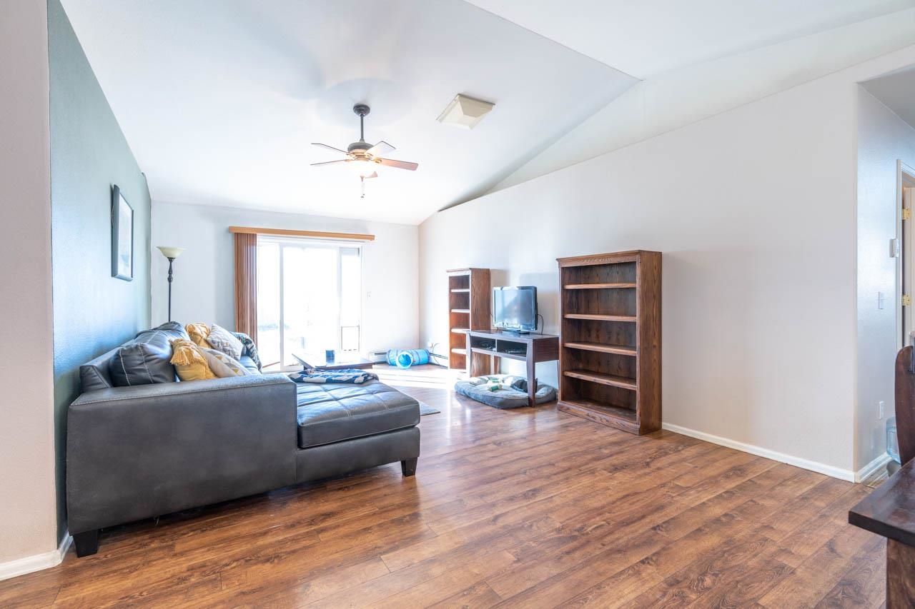 1458 Powell Street Fruita, CO 81521 - Photo 9 of 27 a living room with furniture and a flat screen tv