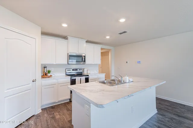 a kitchen with stainless steel appliances refrigerator sink and microwave